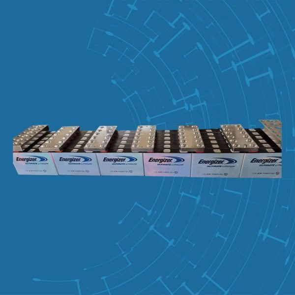 Stack of Energizer lithium batteries on blue background.
