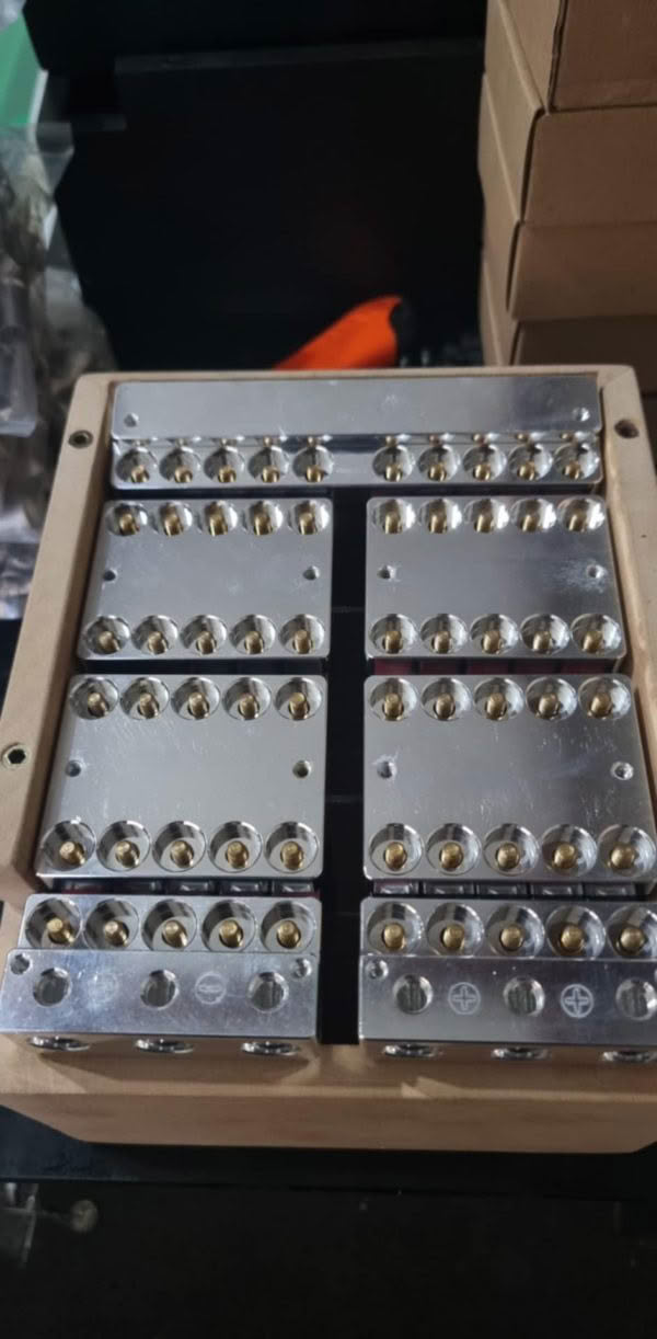Metallic electrical terminal blocks on wooden base