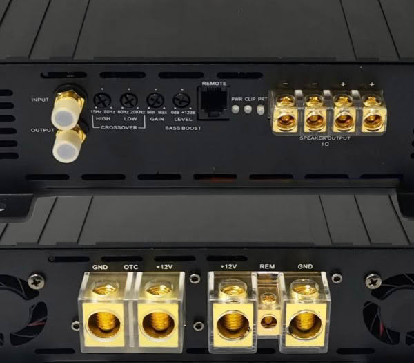 Car audio amplifier connections and controls close-up.