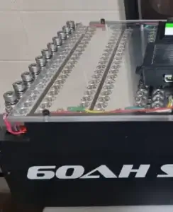 Battery pack with visible cells and connections.