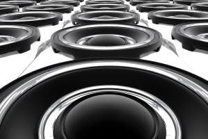 Close-up of multiple black audio speakers.