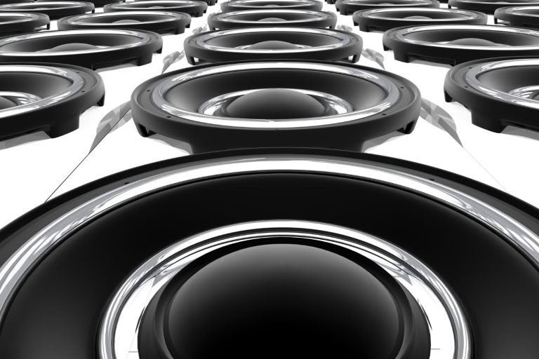 Close-up of multiple black audio speakers.