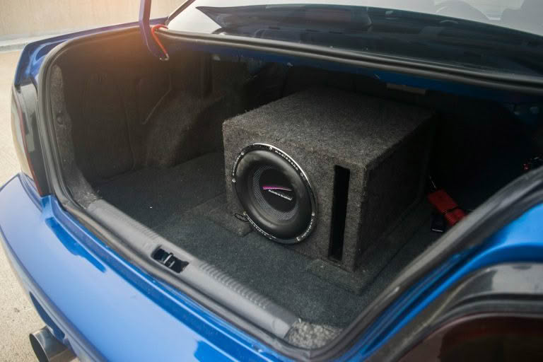 Car trunk with subwoofer box installed.