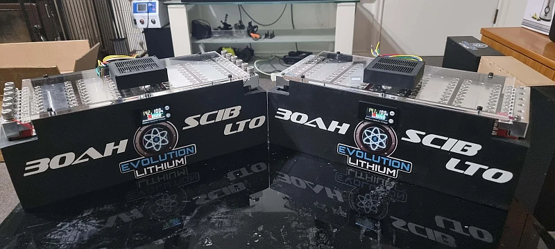 Two 30Ah lithium batteries on display table.