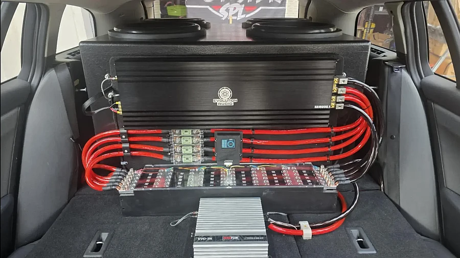 Car audio system with amplifiers and subwoofers installed.