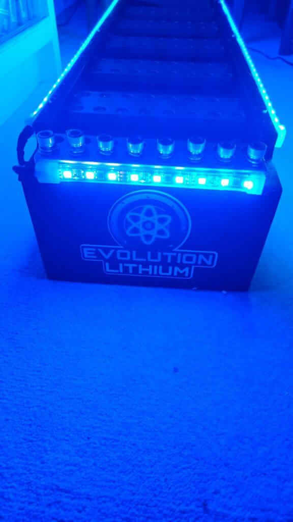 Blue-lit Evolution Lithium battery on carpet.