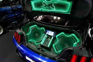 Car trunk with custom audio system and neon lights.