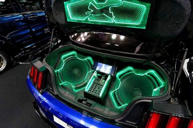 Car trunk with neon-lit subwoofers and sound system