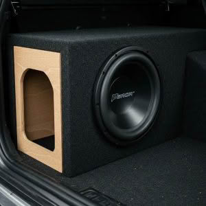 Car subwoofer installed in trunk enclosure