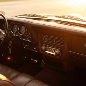 Modern car stereo system highlighting features in a well-lit car interior