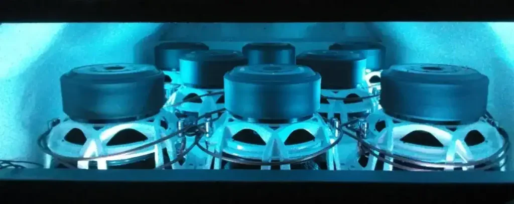 Multiple large subwoofers inside illuminated speaker enclosure