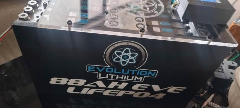 Evolution Lithium battery with specifications and logo, featuring a sleek black design